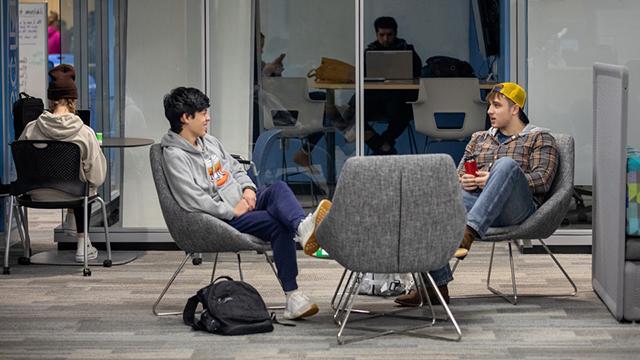 Students chatting in a study space lounge.